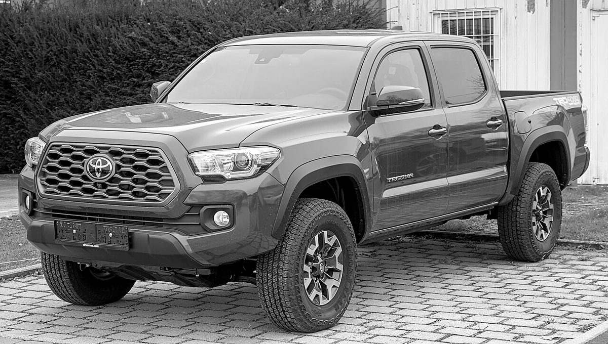 A grey Toyota Tacoma pickup parked on brick pavers
